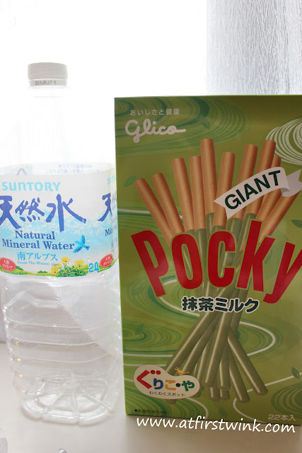 Box of Pocky Giant green tea flavor next to a 2 litre bottle of mineral water