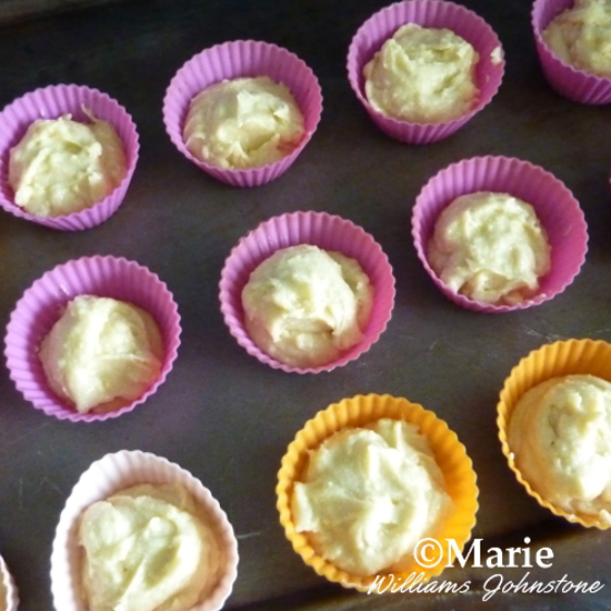 Cupcake mix batter in holders ready to bake in oven