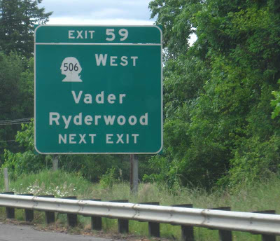 Green Washington State interstate sign for town of Vader, outline of Geo. Washington's head for route number