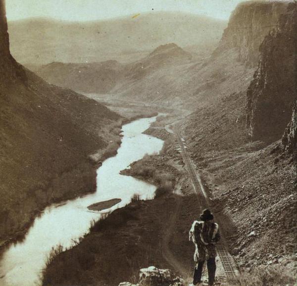 25 Breathtaking Photos From The Past - A Native American looks down at a newly-completed section of the transcontinental railroad. Nevada, about 1868
