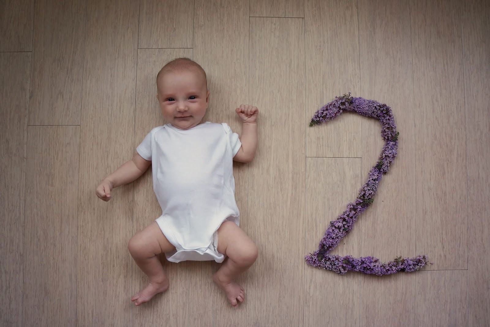 smiling baby with flower number two