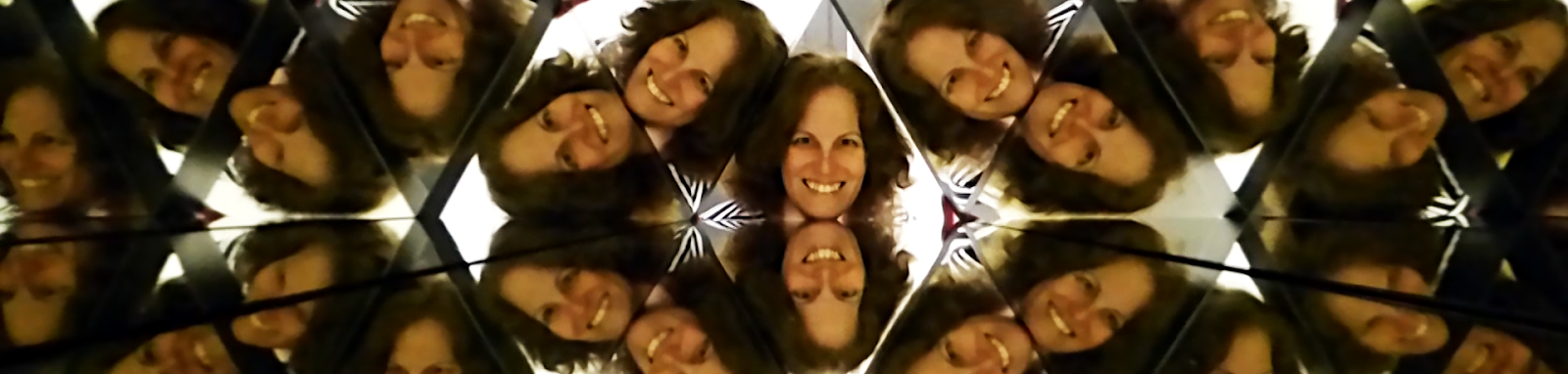 Author Adva Shaviv's face multiplied numerous times in a human-sized kaleidoscope