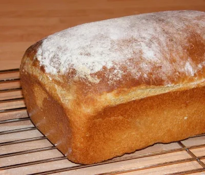 homemade basic white loaf, with floured top on baking rack