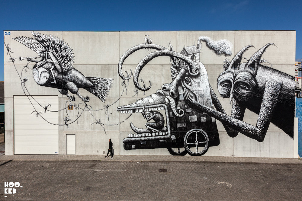 Black and white mural featuring birds and creatures by artist Phlegm