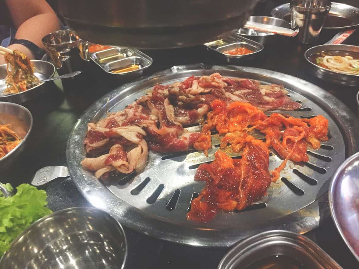 Different kinds of Korean barbecue on the grill at Samgyupsalamat Unlimited Korean Barbecue