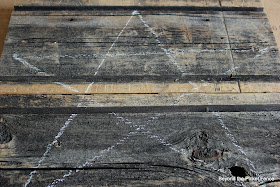 use chalk to draw a star on a barnwood board