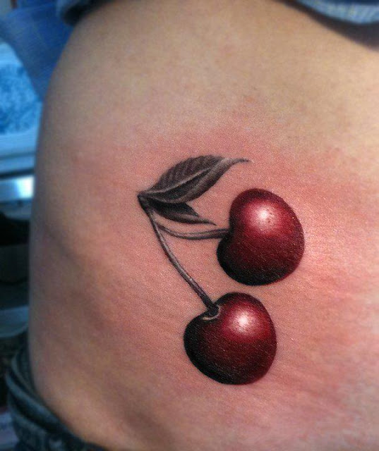 Realistic cherry tattoo on lower back