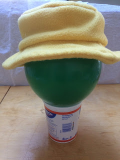 Yellow fleece hat with brim that is mostly horizontal.