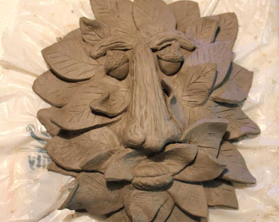 unfired sculpted clay tree face