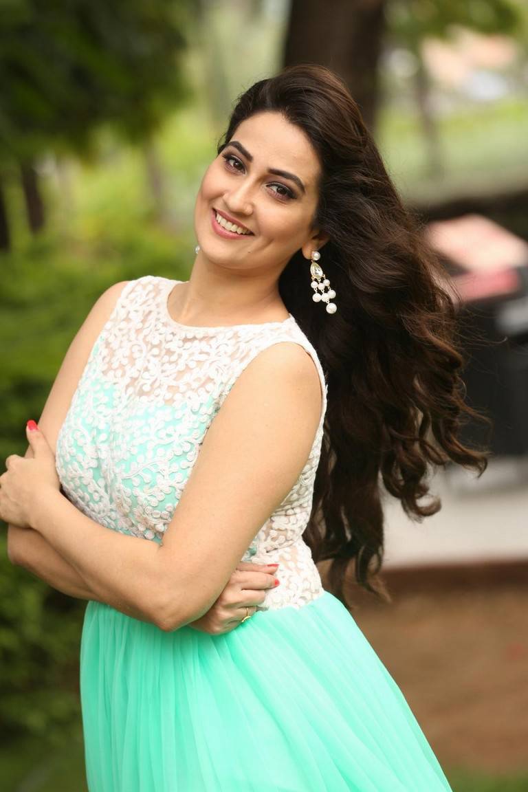 Glamours Tv Anchor Manjusha Stills At Movie Success Meet In Green Dress