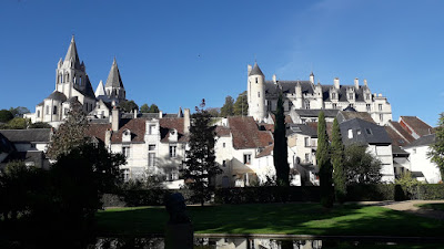 Loches under a blue October sky, looking up from gardens at the chateau and church of St.Oars