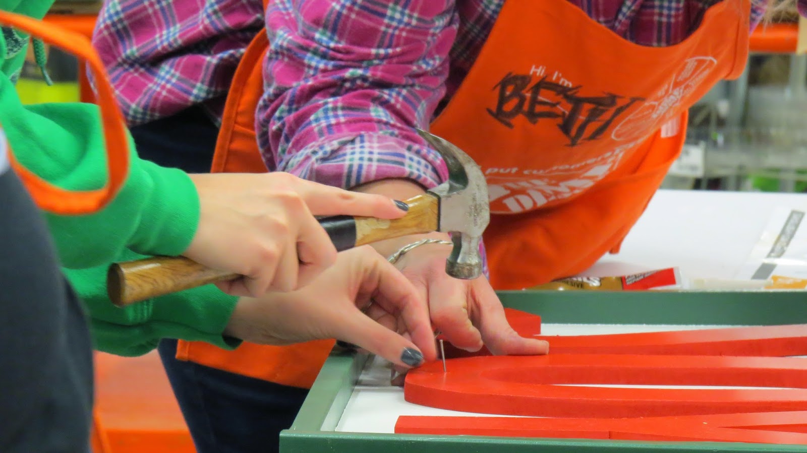 Learning how to build Joy Marquee Sign at Her It Yourself Workshop, Hammer, Nails, Instruction