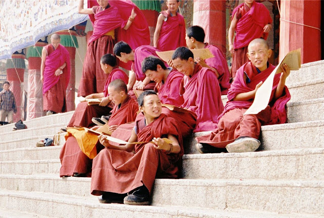 Young monks at the footsteps of the Labrang Monastery in Xiahe, China