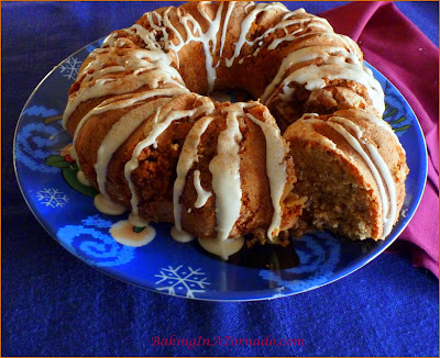 Sweet Potato Pecan Cake with Maple Glaze, a moist holiday cake with a hint of sweet potato, a cinnamon ,maple swirl center and a hint of maple maple in the glaze. | Recipe developed by www.BakingInATornado.com | #recipe #cake #holiday