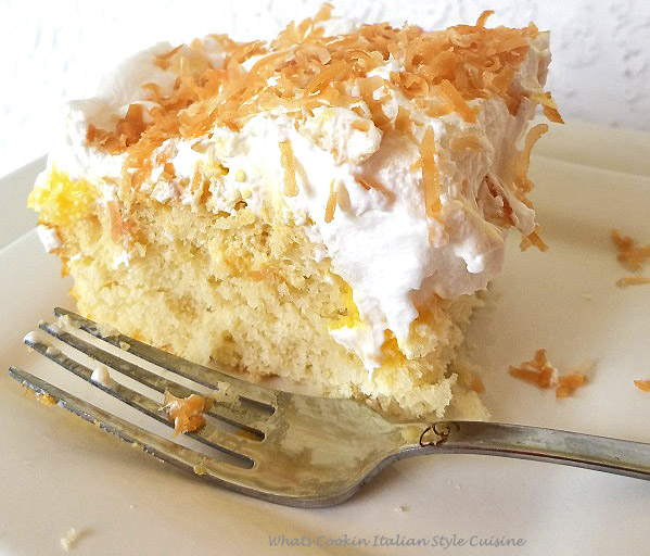 This is a  slice of coconut cake with coconut cream pudding that is called poke cakes because you poke holes in the cakes and the coconut cream pudding is throughout the cake then piled high with whipped cream and toasted coconut on top this recipe shows how to make poke cake