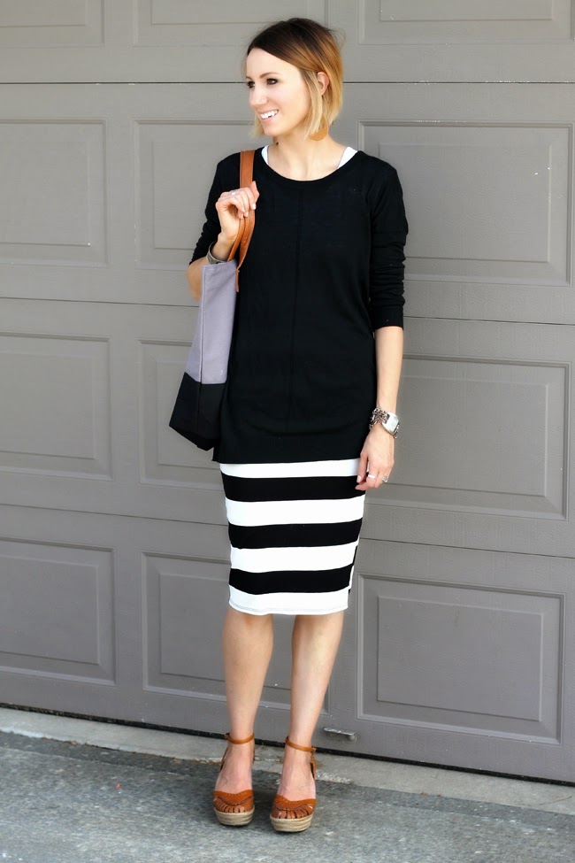 Long black sweater, striped knit skirt and clogs