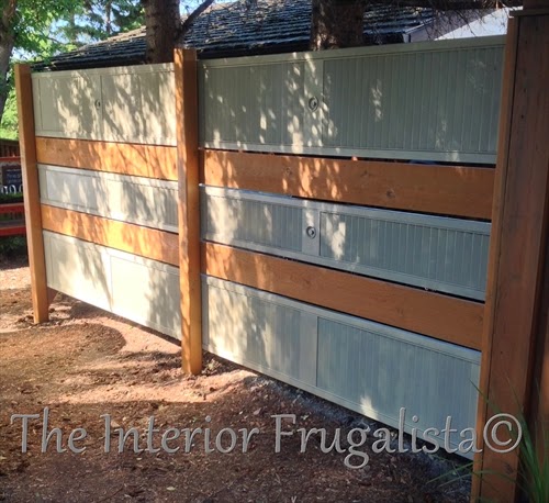 A budget-friendly DIY Privacy Fence or Garden Screen idea made with salvaged and repurposed wooden louvered bi-fold doors, a unique outdoor fence idea.