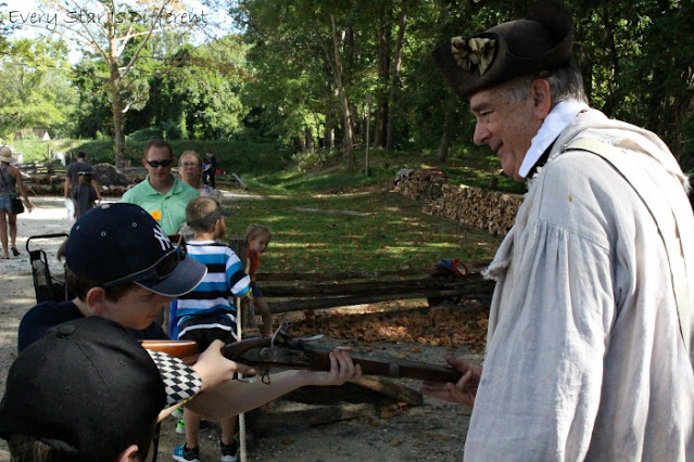 Handling a musket at the American Revolution Museum at Yorktown.