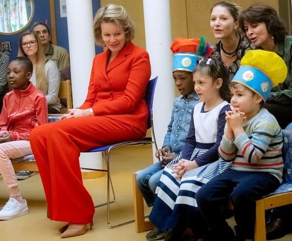 Queen Mathilde visited Queen Fabiola Children's University Hospital. The Queen wore a double breasted orange blazer by Ralph Lauren