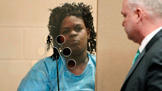 In this Feb. 6, 2018 file photo, Latarsha Sanders, 43, is arraigned in Brockton, Mass., District Court on two counts of murder. When asked by police why she stabbed her older son, Sanders told police 'it was because of the voodoo stuff,' according to court documents. (Marc Vasconcellos/Enterprisenews.com via AP, Pool, File)