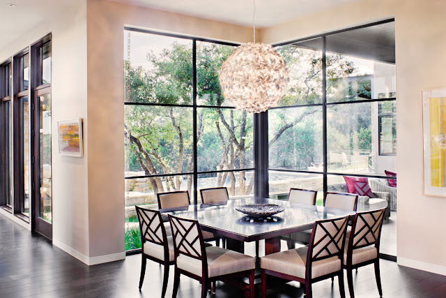 Photo of square dining table by the glass wall in the dining room
