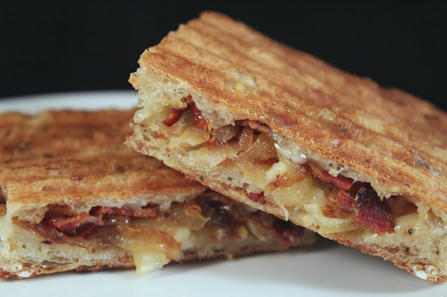Caramelized onion, bacon, and cheddar panini on seeded focaccia