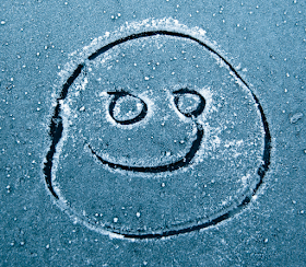 smiley face drawn on frozen windscreen