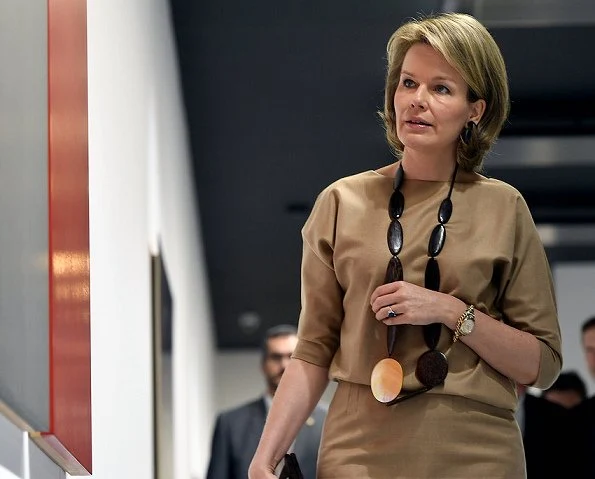 Queen Mathilde visited BPS22 Art Center in Charleroi. Queen mathilde wore Dries Van Noten dress and Delphine Nardin Gold Earrings, carried DFV Elaphe clutch