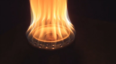 Flames roar out of a Penny stove / Beer Can stove