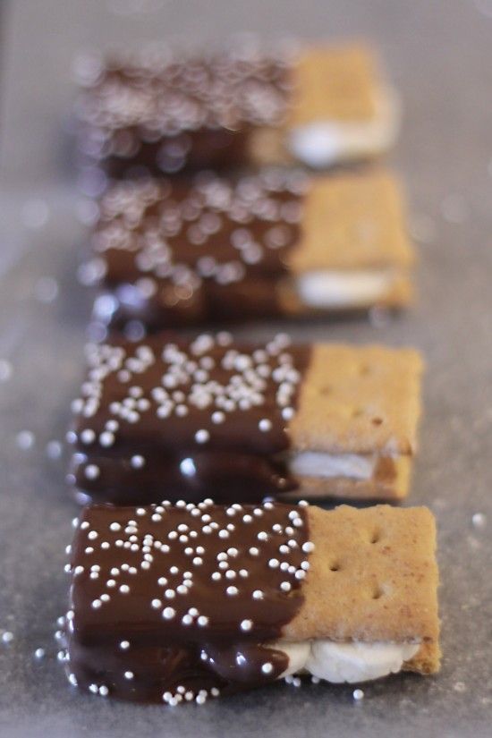 Dipped s'mores graham crackers with ‘fluff’ in the middle. dipped in