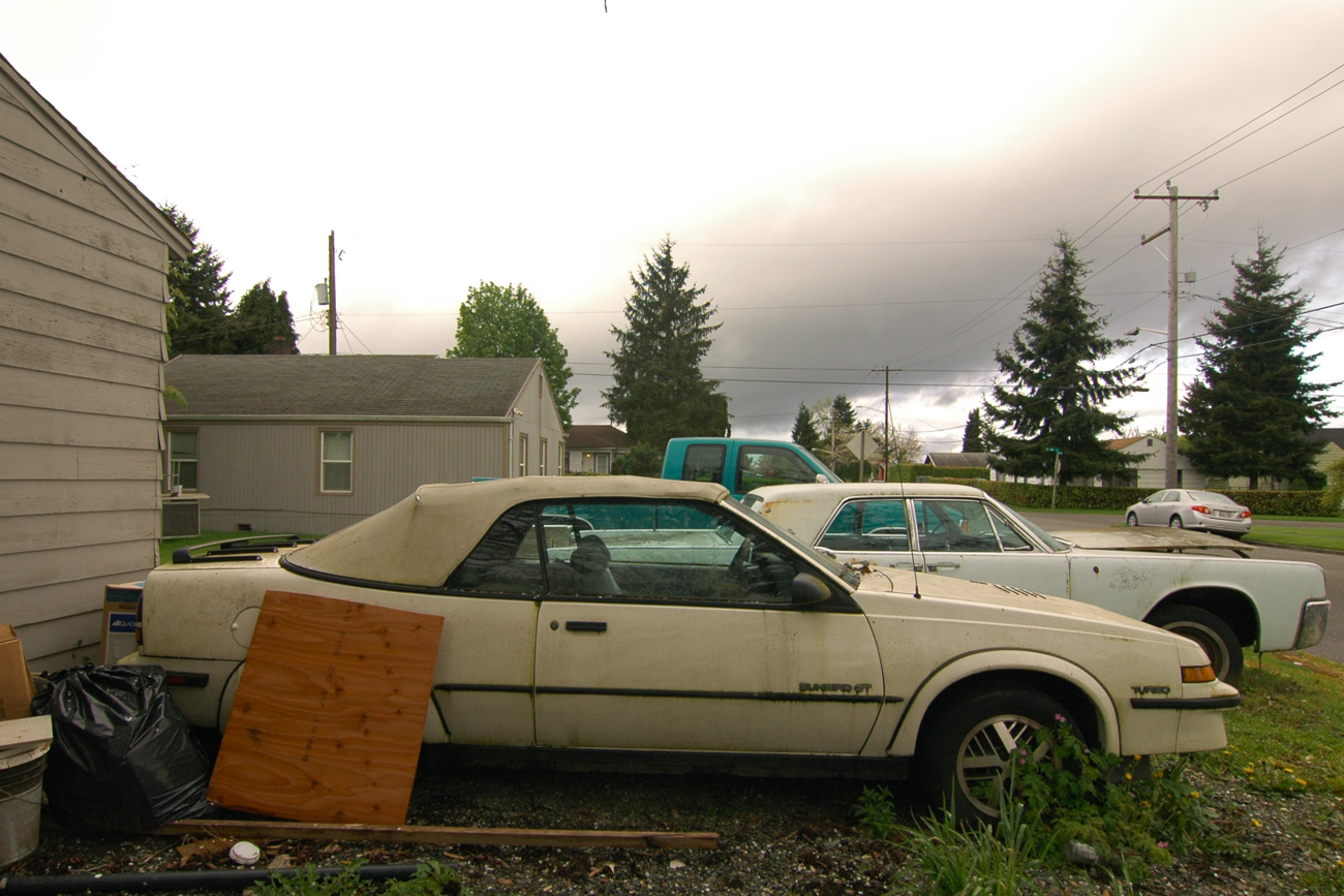 OLD PARKED CARS.: 1988 Pontiac Sunbird GT Turbo Convertible.