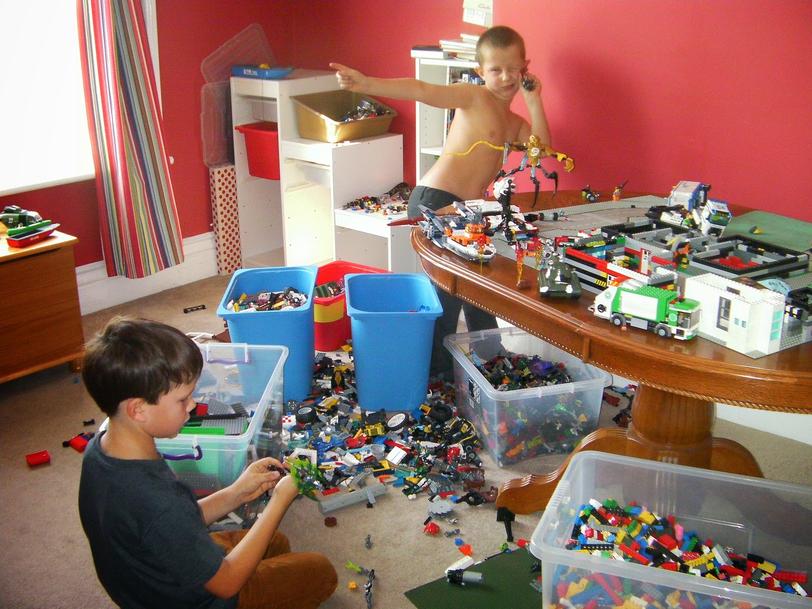 schoolboys making lego heroes and lego buildings shirtless boy and giant lego collection boss from monsters inc