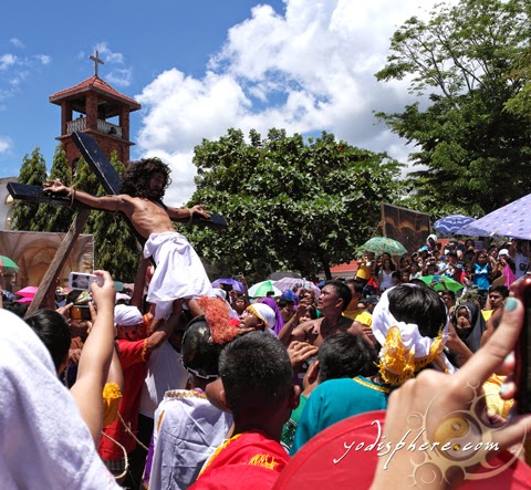 Man with his palms and feet nailed in cross as part of Holy Week celebration