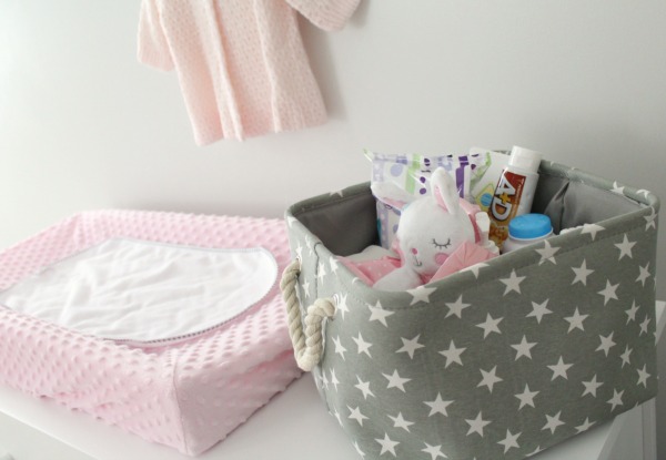Gray white and light pink nursery for a baby girl- pink minky changing pad cover and gray canvas and rope basket with stars as a diaper caddy