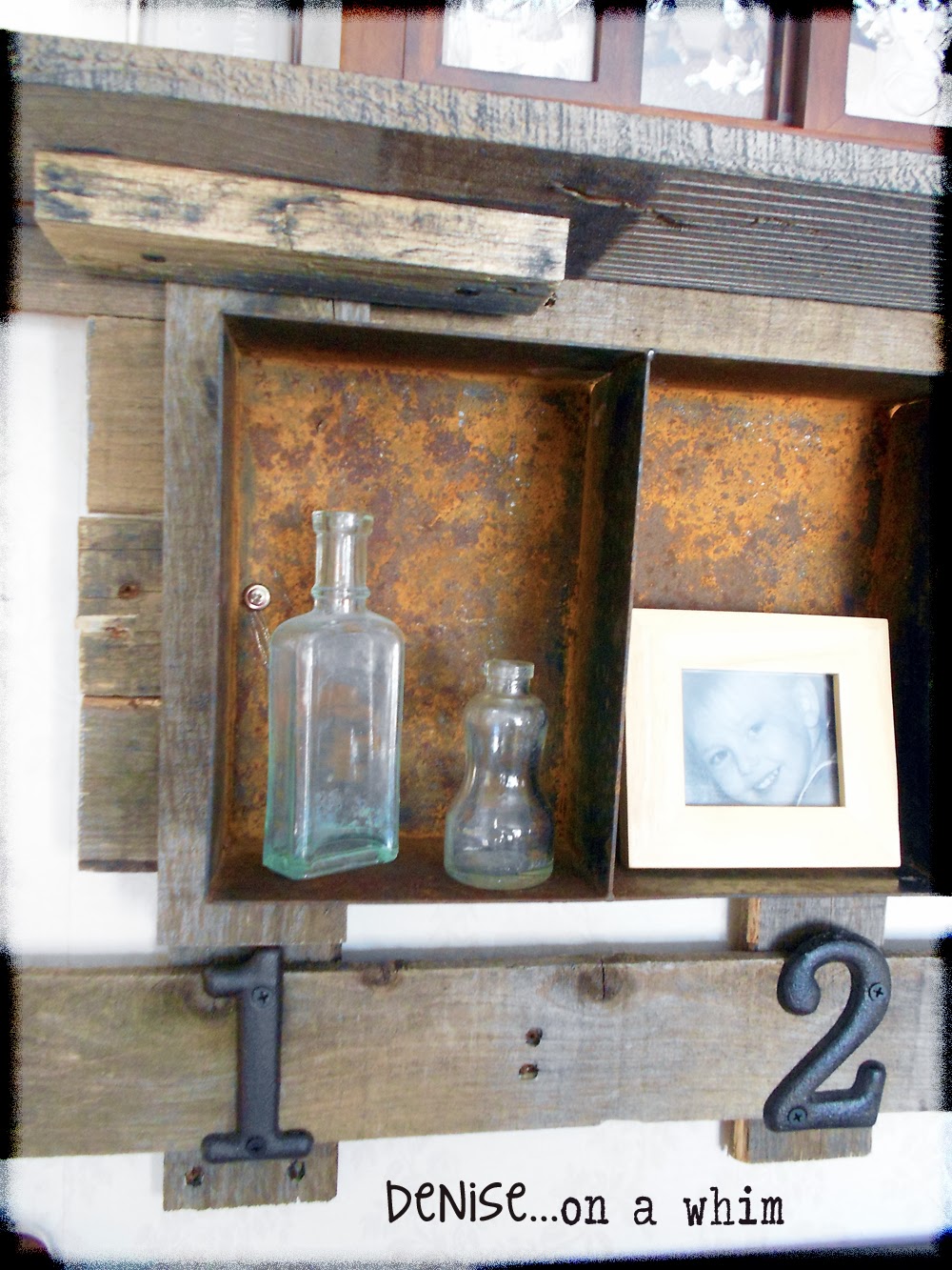 A rusty bin turned shelf for displaying small items via http://deniseonawhim.blogspot.com