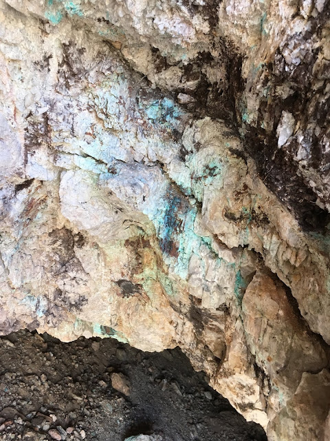 Rock showing evidence of mineral copper Light blue tinge to the rocks on the mine walls