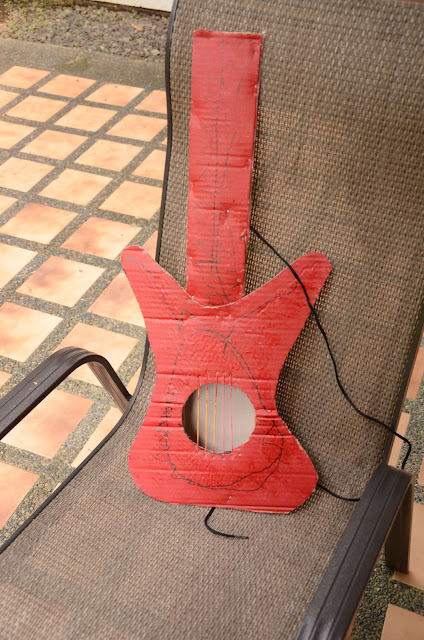Kecil's red cardboard guitar
