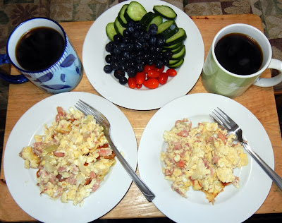 Scrambled eggs, cucumber and tomato slices, blueberries and coffee!