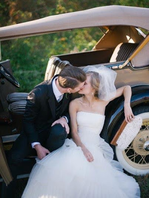 Bride and groom with antique car