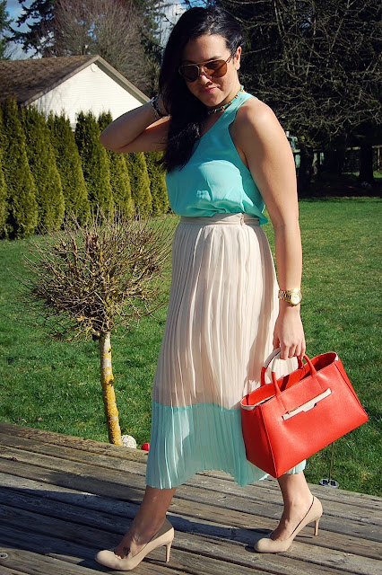 Mint silk tank and pleated maxi skirt with an orange Saffiano Furla bag.