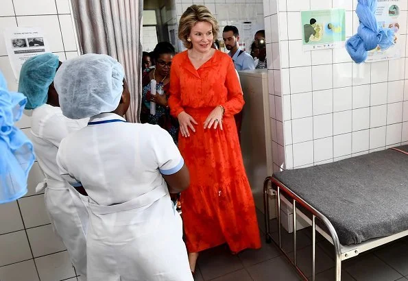 Queen Mathilde wore a red midi dress by Belgian fashion house Natan, and gold earrings by Natan