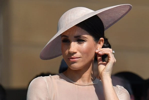 Meghan Markle wore Goat Fashion Flavia Dress, and Tamara Mellon 'Siren' blush nappa leather pumps, she carried Wilbur and Gussie bespoke silk clutch