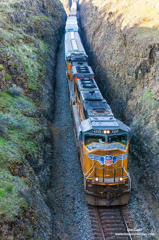A train passes through a carved out route in the Palouse near Palouse Falls State Park, Washington, USA.
