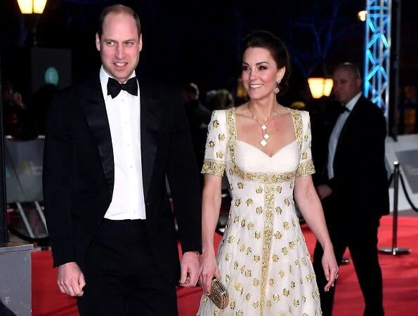 The Duchess wore a gown by Alexander McQueen. Jimmy Choo Romy gold pumps, She carries Anya Hindmarch gold glitter box clutch