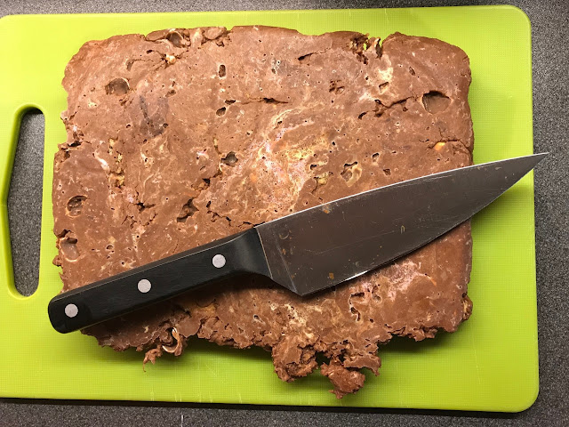 Rocky Road on a chopping board with a sharp knife