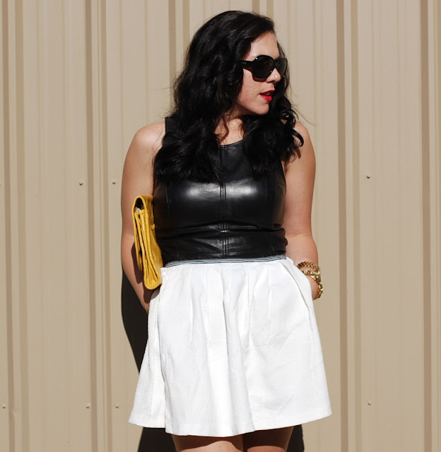 Leather peplum top and white tulip skirt with a yellow Marc by Marc Jacobs clutch.