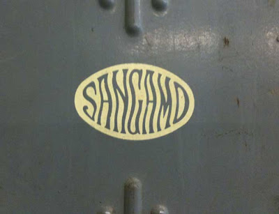 Wavy Sangamo lettering on a metal door