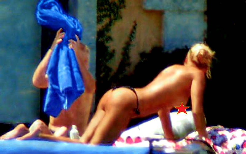 Anna Kournikova caught suntanning topless.