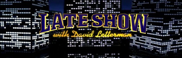 Late Show with David Letterman title against backdrop of tall city buildings at night with random pattern of lit windows