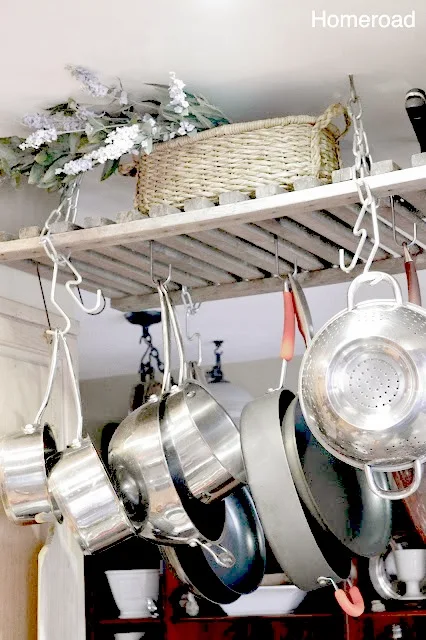 wooden pot rack with pots and basket